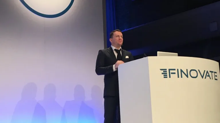 Speaker presenting at a podium at the Finovate conference