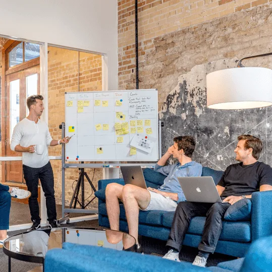 People sitting looking at a whiteboard