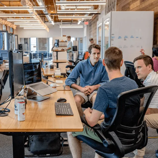Team members working together at desks in an open office